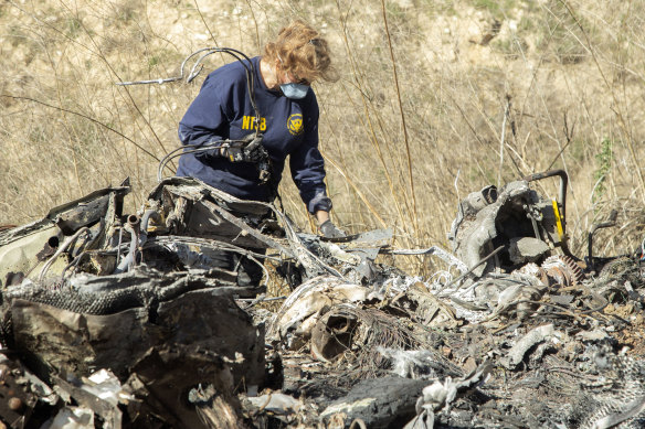 An investigator examines wreckage from the helicopter crash that claimed the lives of Kobe Bryant and his daughter Gianni.
