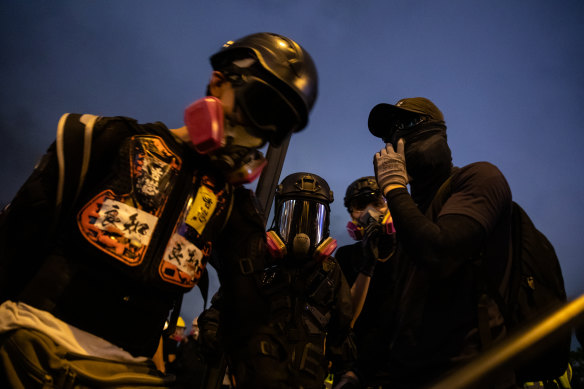 Demonstrators wear gas masks during a strike rally at Tamar Park.
