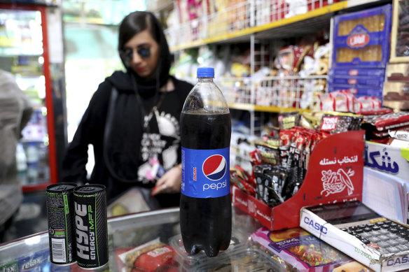 An Iranian customer buys a Pepsi in a grocery store in downtown Tehran. 