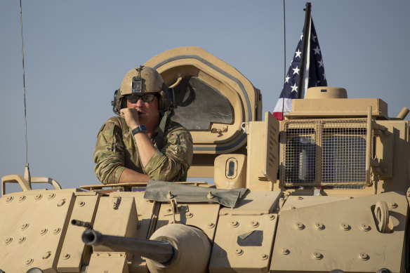 A US soldier looks out of a tank at an American base at undisclosed location in north-eastern Syria.