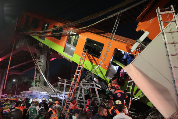 Emergency personnel work to search for accident survivors after a raised subway track collapsed in Mexico City, Mexico. 