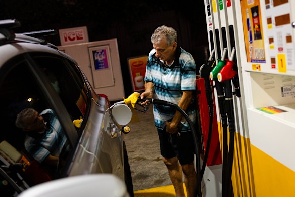 Sam Aiello fills up petrol at a Sydney service station on Thursday morning.
