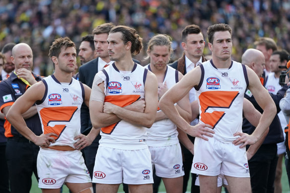 A dejected Phil Davis of the Giants (second from left) during the presentations .