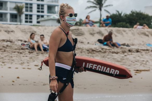  A lifeguard wearing a protective mask stands guard Delray Beach in Florida.