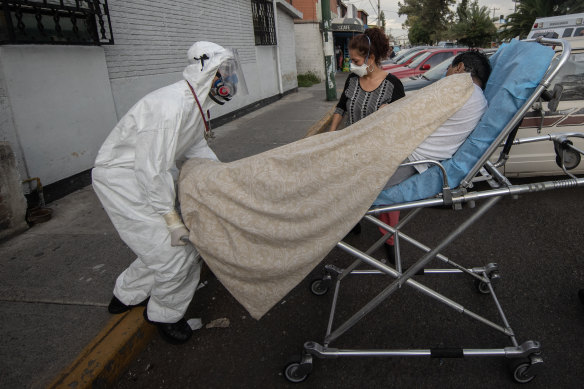 A suspected coronavirus patient is taken to an ambulance in Mexico City on Friday.