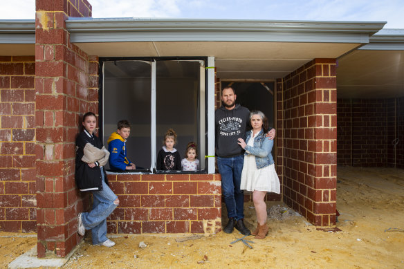 Zoe-Marie and Joel Masters with their children Temperance (12), Max (10), Grace (4) and Lilly (2) outside their unfinished home in Mandogalup.