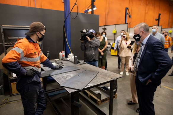 Anthony Albanese speaks to a rail worker at Aries Rail on Thursday in Perth.