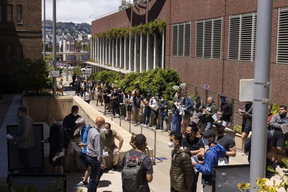 People stand in long lines to receive the monkeypox vaccine at San Francisco General Hospital on July 12, 2022.