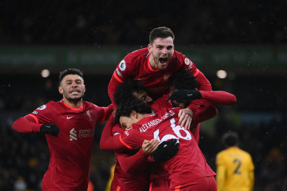 Divock Origi is swamped by his Liverpool teammates after scoring the stoppage time winner.