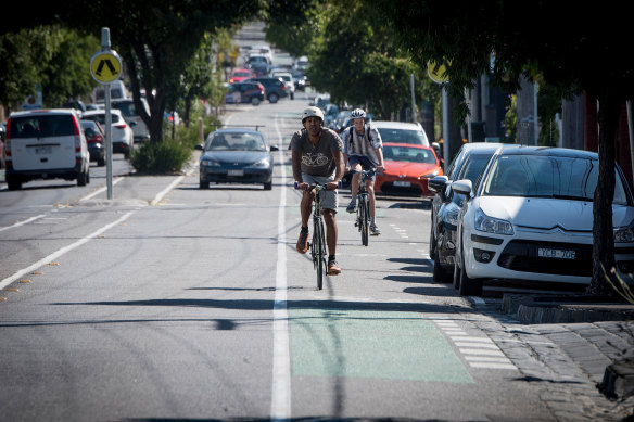 Cyclists riding along Wellington street in Collingwood where a 30 kilometre an hour speed limit is being trialled.