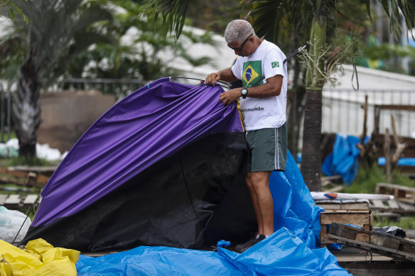 A supporter of former Brazilian president Jair Bolsonaro breaks camp outside a military base in Rio de Janiero, Brazil, on Monday. New President Luis Inacio Lula da Silva ordered all makeshift camps gone within 24 hours.