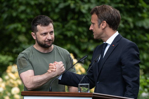 Ukrainian President Volodymyr Zelensky and French President Emmanuel Macron shake hands after a press conference in Kyiv on June 16.