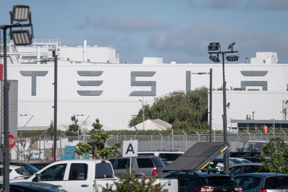 The electric carmaker was accused of turning a blind eye to racial taunts and offensive graffiti the man endured at its auto plant in Fremont, California.