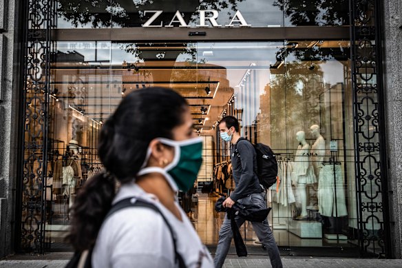 Pedestrians wear protective face masks in Barcelona, Spain. 