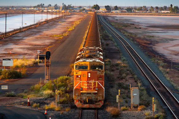 A BHP train carries iron ore to Port Hedland. The miner relies on China for half its revenue.