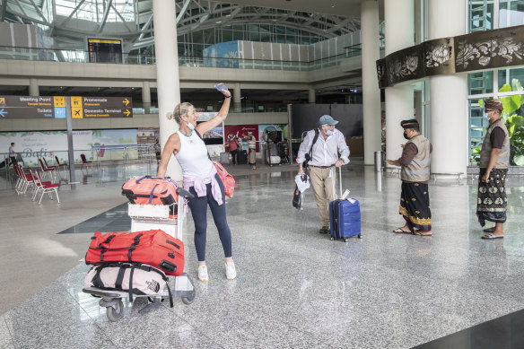 Travelers arrive at Ngurah Rai International Airport in Bali, Indonesia.
