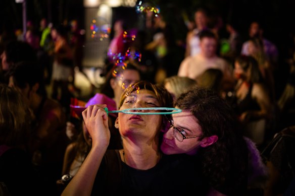 Joyous spectators watch on as parade participants make their way down Oxford Street. 