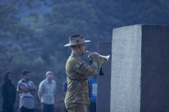 The Last Post is played at the Isurava memorial.