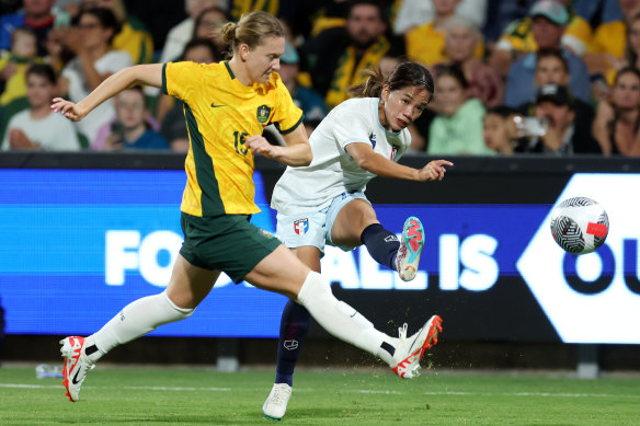 Clare Hunt of the Matildas tries to block a kick by Ting Chi of Chinese Taipei.