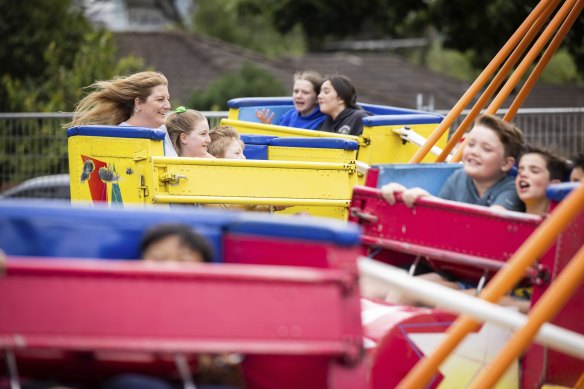 Families enjoy a ride at Our Lady’s Ringwood school fete.
