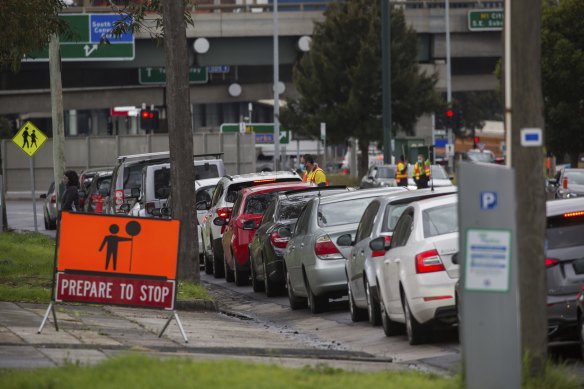 Hundreds of people line up in their cars for a COVID-19 test in South Melbourne on Wednesday.