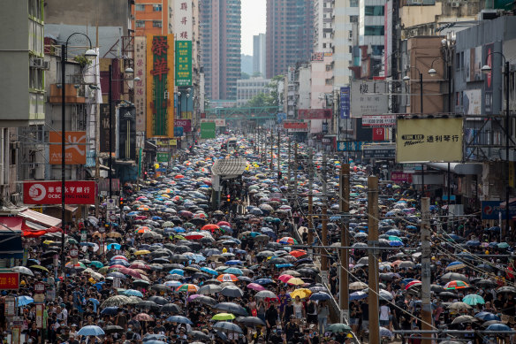 Demonstrators walk on the main street during a protest in the Yuen Long district of the New Territories in Hong Kong, China, on Saturday.