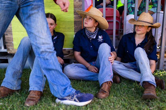 From left: Olivia, Olive and Georgie watch the cattle lawns prepare for the Royal Easter Show at Sydney Olympic Park on Wednesday. 