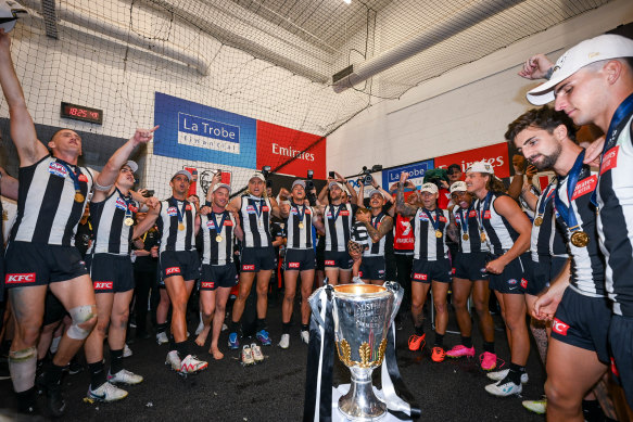 Collingwood celebrate with the 2023 AFL premiership trophy.