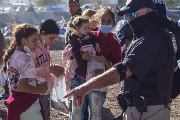 Migrants go through in a new mobile processing centre, which was set up close to the Paso del Norte International Bridge on the US-Mexico border, in El Paso. 