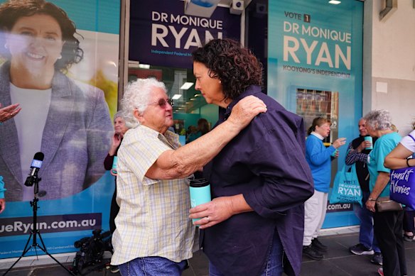 Ryan hugs Davina Lipmann from action group Grandmothers for Refugees.