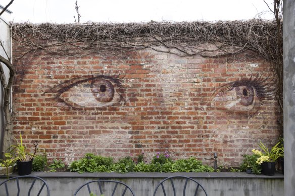 A mural in Sandra and Andrew’s garden by Rone, one of many of his works the couple owns.
