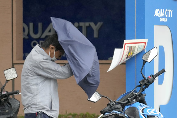 A man holds un umbrella against strong wind and rain on Tuesday in Tokyo.