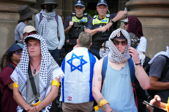 A man wearing Israel’s flag as a cape at the rally.