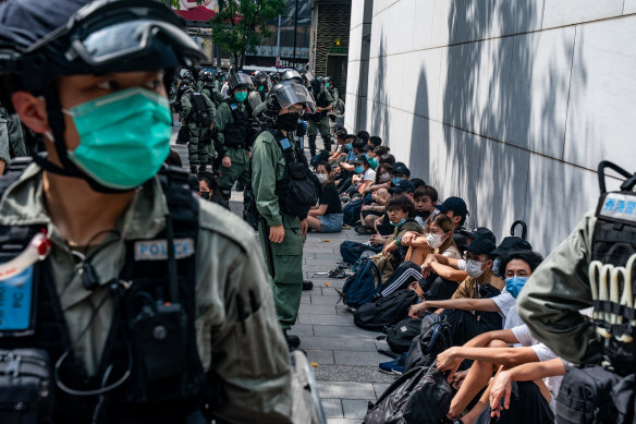 Riot police detain pro-democracy protesters during a rally in Hong Kong's Causeway Bay district on Wednesday. 