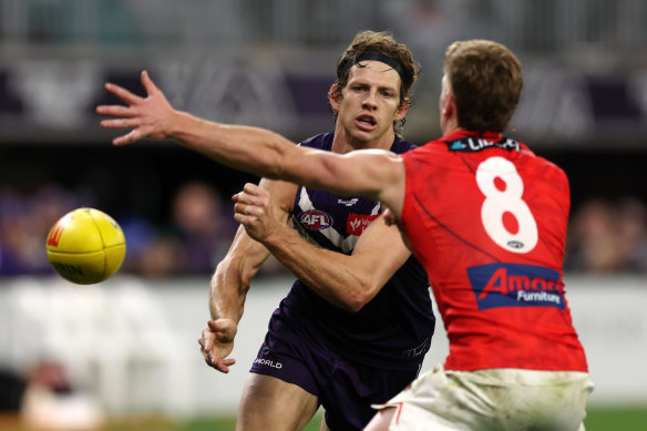 Dockers star Nat Fyfe handballs out of trouble against the Bombers.