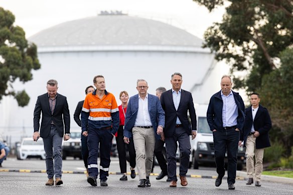 Prime Minister Anthony Albanese (centre) visits the Viva refinery in Corio on Friday.