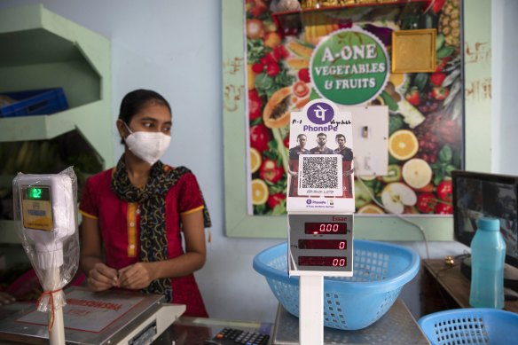 A store displays a poster for a payment app in Bengaluru. The Modi government-backed payment infrastructure processed 11.4 billion transactions in October.