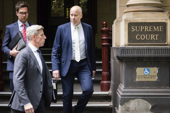 Michael Bachelard (right), acting editor of The Age, leaving the Supreme Court of Victoria on Thursday.