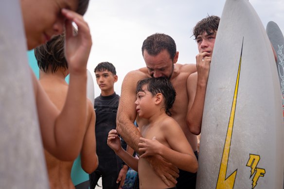 The Lopez family at the community paddle-out. Kai Lopez, right, was Nic’s best friend.
