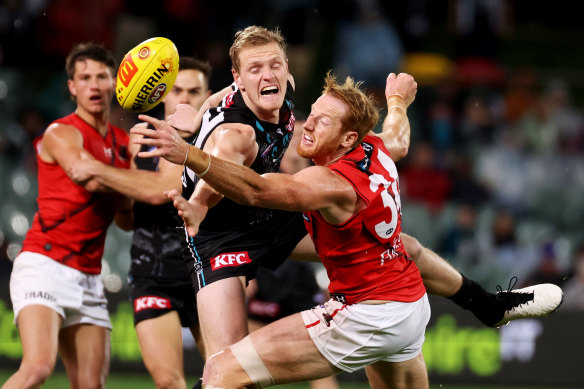 Sam Hayes of the Power competes with Essendon’s Andrew Phillips.