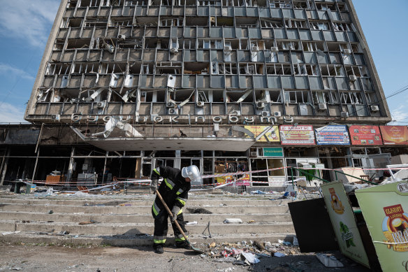 A rescuer clears away rubble by the heavily damaged office building in Vinnytsia, Ukraine, on Friday.