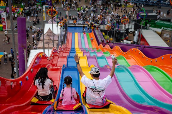 People enjoy the rainbow slide on the second day of the Royal Easter Show at Sydney Olympic Park.