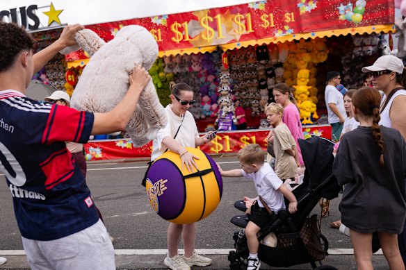 Phoenix, 3, reaches for his new toy at the show.
