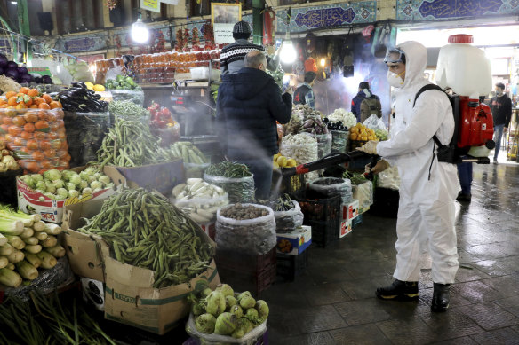 Fresh fruit and vegetable stands are disinfected in Tehran.