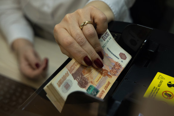 The value of the Russian rouble has tumbled to a record low against the US dollar after financial sanctions against Russian financial institutions were ratcheted up over the weekend.