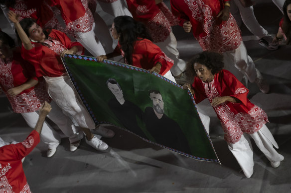 Performers hold a sign with the image of British journalist Dom Phillips and indigenous activist Bruno Pereira as the Salgueiro samba school parades. Phillips and Pereira were murdered during a trip through Vale do Javari, in the Amazonas state. 