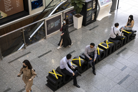 Seats inside a shopping mall in Singapore are marked to prevent people sitting too close to each other.