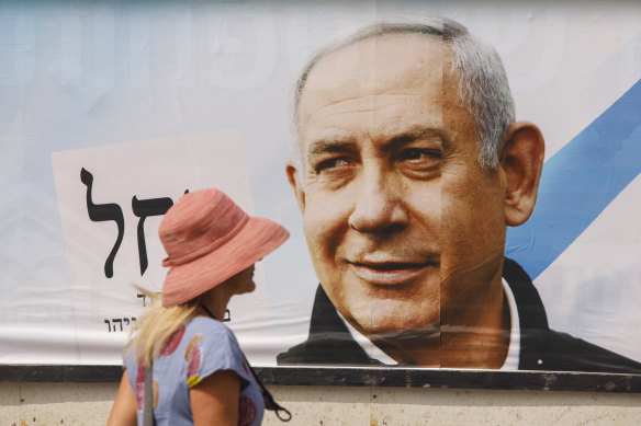 A pedestrian passes an election campaign billboard for Benjamin Netanyahu, Israel’s prime minister and the leader of the Likud party, in Tel Aviv, Israel.