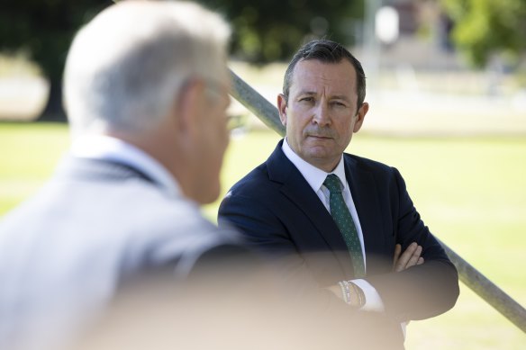 Two men in their 50s have been charged after allegedly threatening Premier Mark McGowan in two separate incidents.