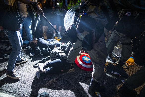 Riot police stand around demonstrators lying on the ground during a protest in the Yuen Long district of the New Territories in Hong Kong on Saturday.
